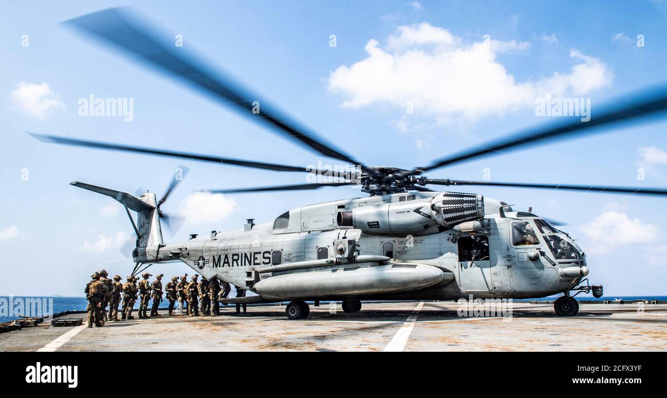 SOUTH CHINA SEA (Sept. 6, 2020) Force Reconnaissance Marines with Command Element, 31st Marine Expeditionary Unit (MEU) board a CH-53 E Super Stallion helicopter with Marine Medium Tiltrotor Squadron (VMM) 262, for extraction during a visit, board, search and seizure exercise aboard the amphibious dock landing ship USS Germantown (LSD 42). Germantown, part of the America Amphibious Ready Group assigned to Amphibious Squadron 11, along with the 31st Marine Expeditionary Unit, is operating in the U.S. 7th Fleet area of responsibility to enhance interoperability with allies and partners, and serv Stock Photo