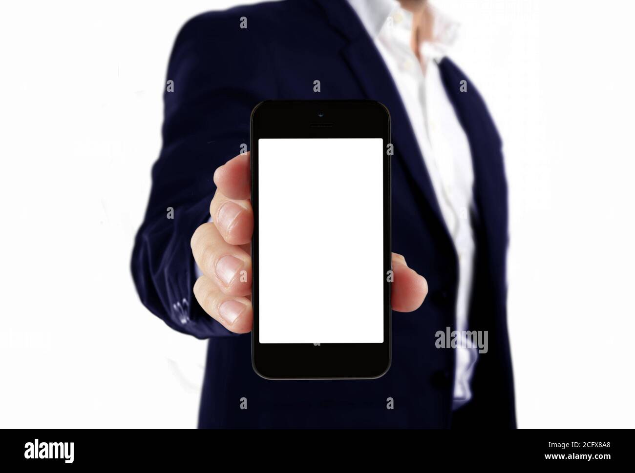 Man in suit holding blank smartphone Stock Photo