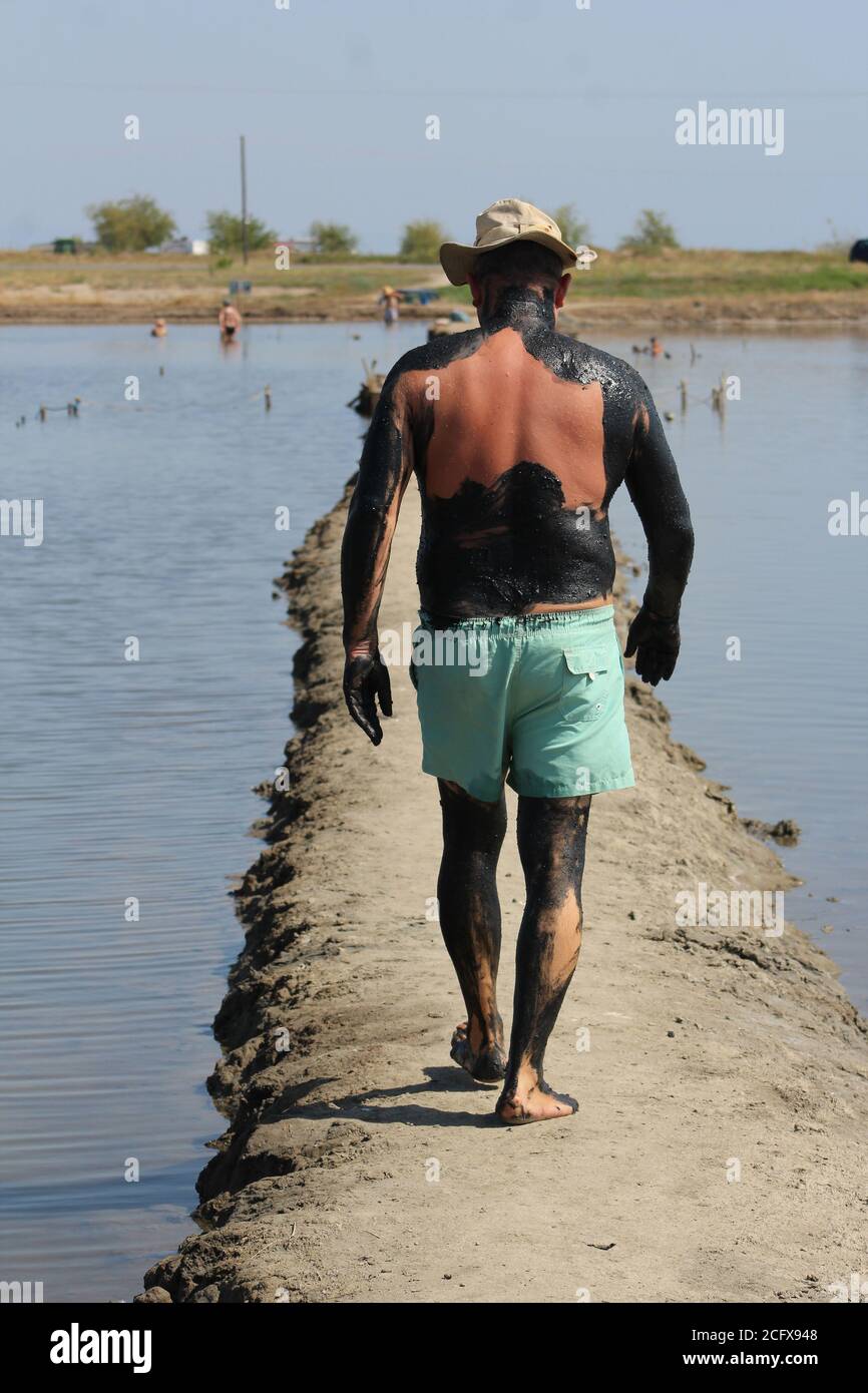 Visitors enjoy the mudbathing process to help people who suffer from