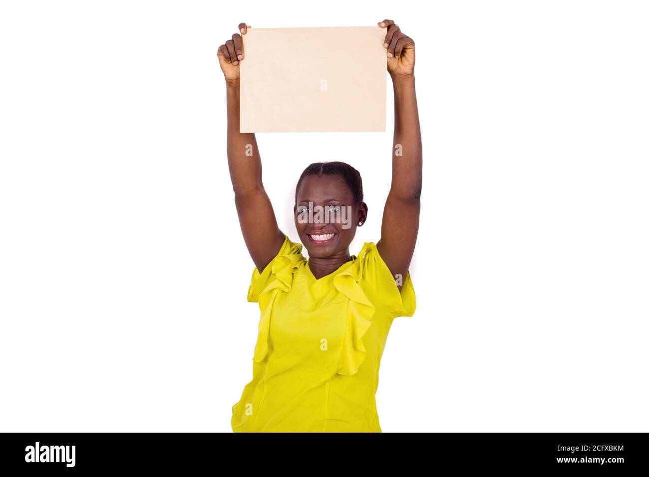 Smiling woman showing a blank sheet of paper with copy space for ...