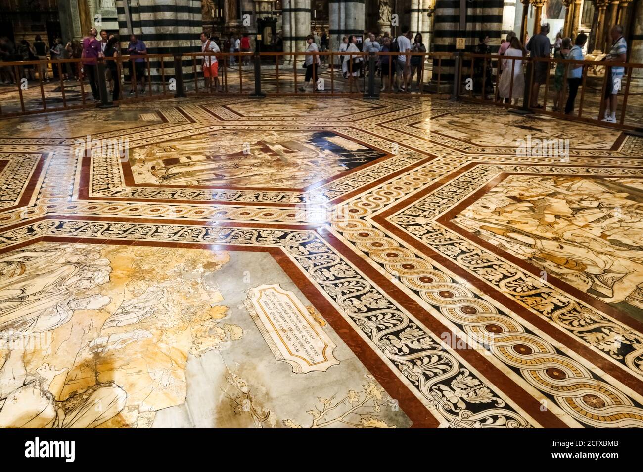 Gorgeous close-up view of the inlaid marble mosaic floor of the transept in the Siena Cathedral. The hexagonal shaped panels represent sibyls, scenes... Stock Photo