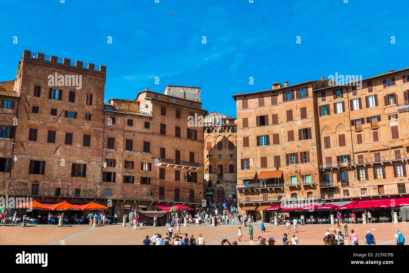 Gorgeous panorama photo of various palazzi signorili with a gap caused by the Costa Barbieri street; surrounding the famous Piazza del Campo on a... Stock Photo