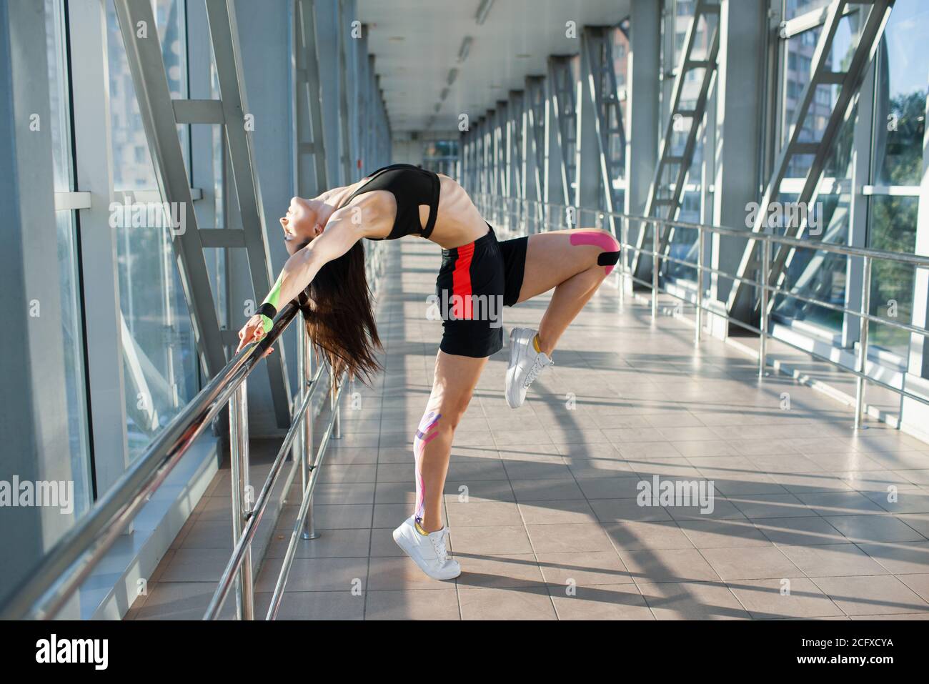 side-view-of-muscular-brunette-woman-practicing-gemnastics-pose-young