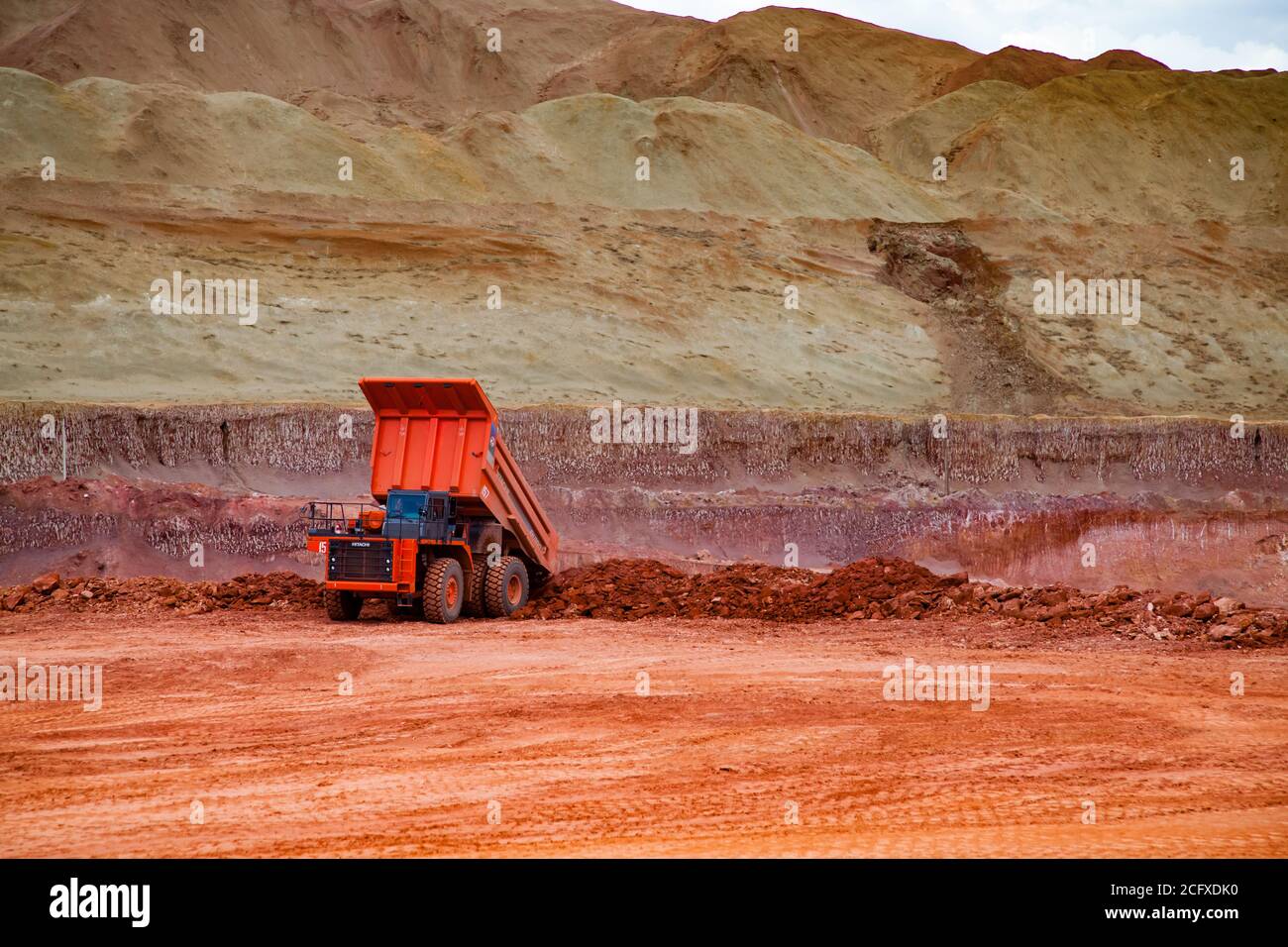 Bauxite clay mine. Aluminium ore mining and transporting. Hitachi dump