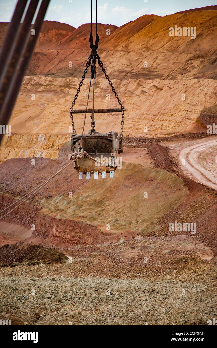 Aluminium ore quarry. Bauxite clay open-cut mining. Walking dragline excavator bucket. Stock Photo