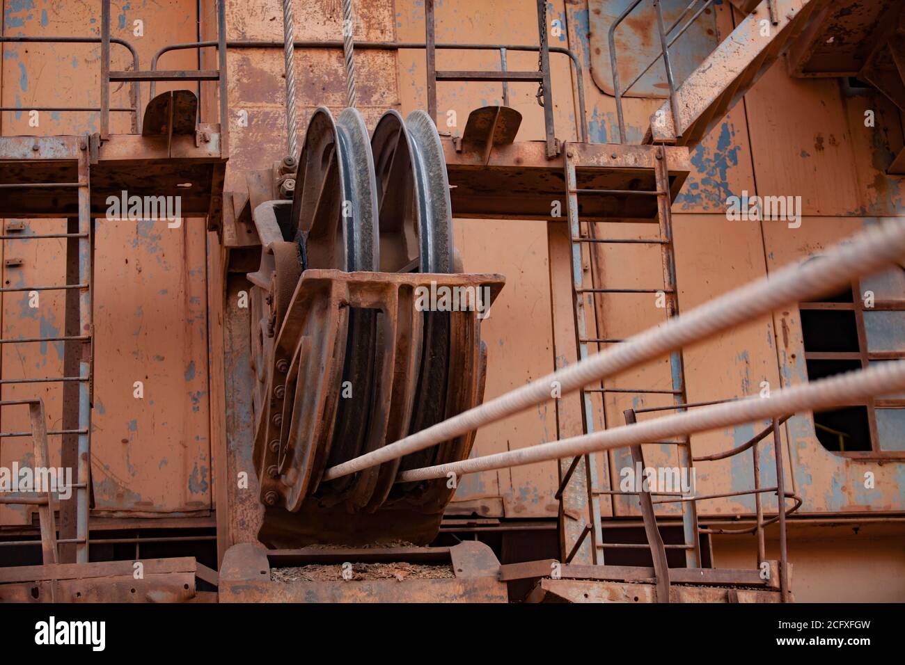 Aluminium ore quarry. Bauxite clay open-cut mining. Giant walking dragline excavator. Steel cables and a rolls. Close-up. Stock Photo