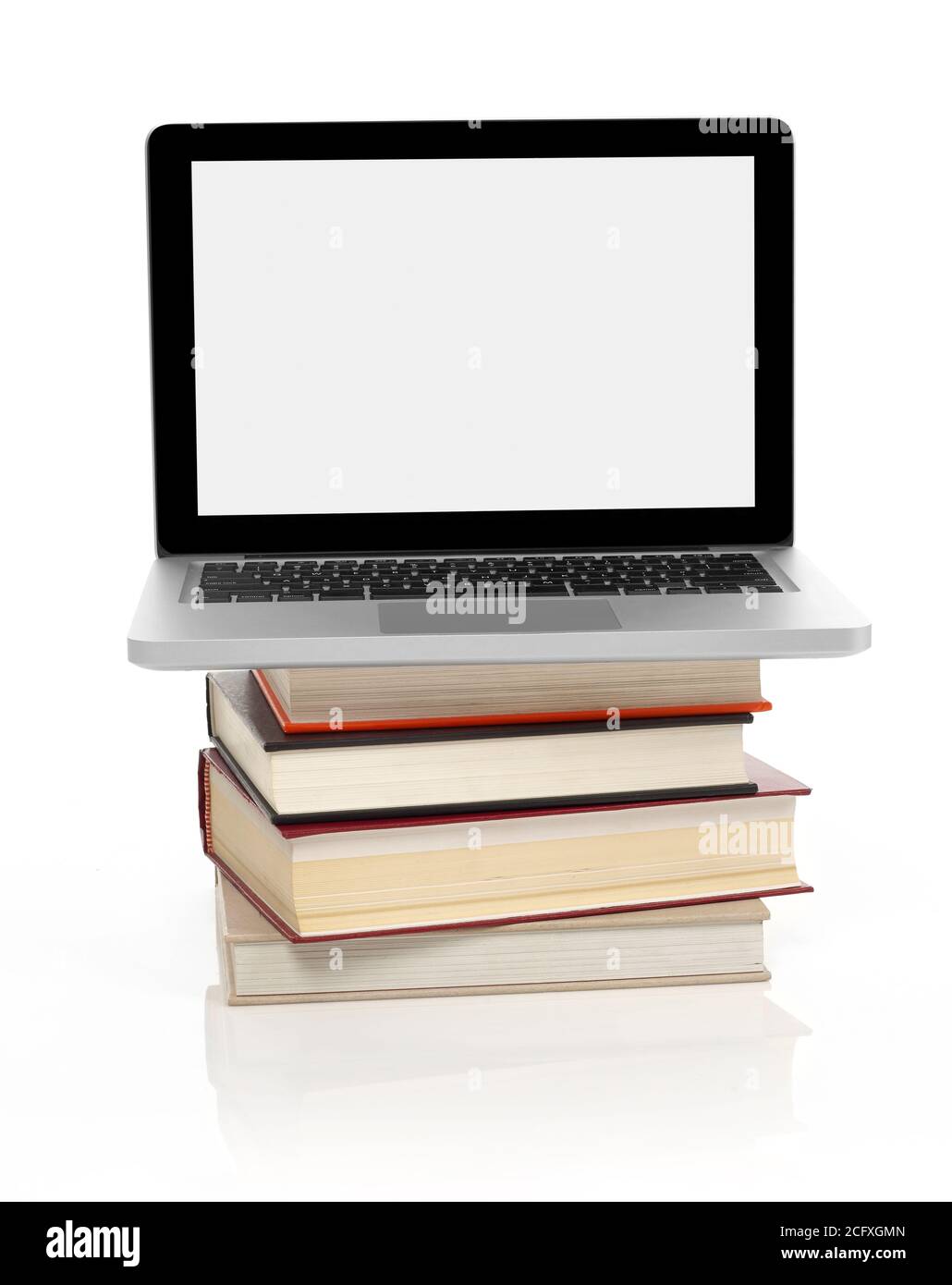 Laptop on a stack of books, white background Stock Photo