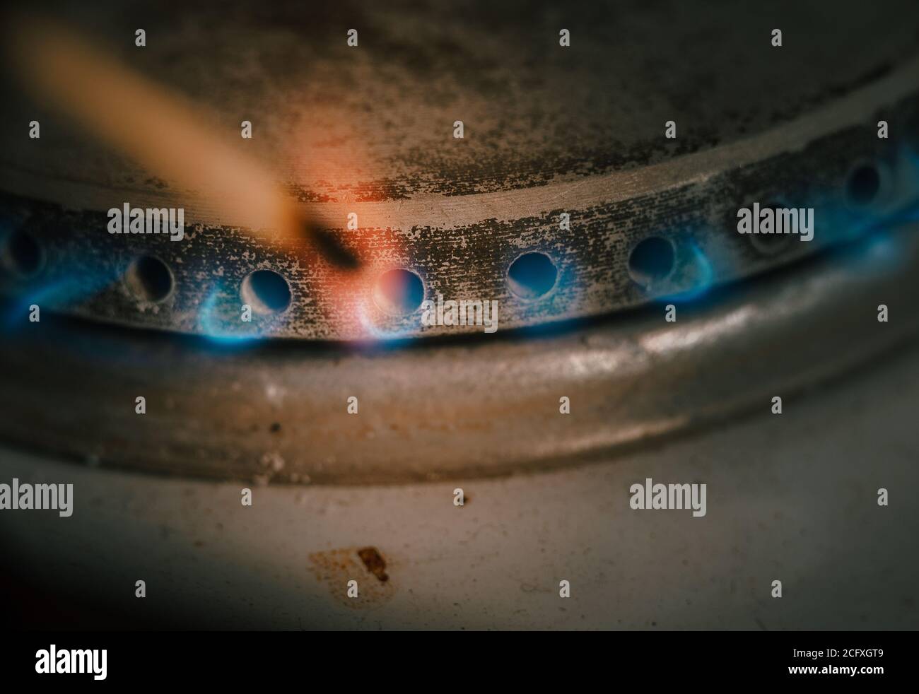Blue flames of propane burner ignite match. Burner gas stove, concept