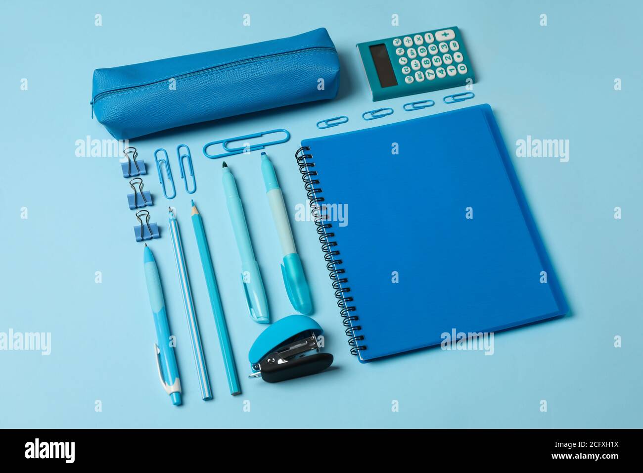 Flat lay with different school supplies on blue background Stock Photo
