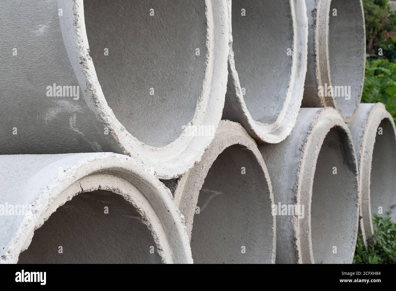 Close up. Concrete pipes used for drainage and road side in a big city. Stock Photo