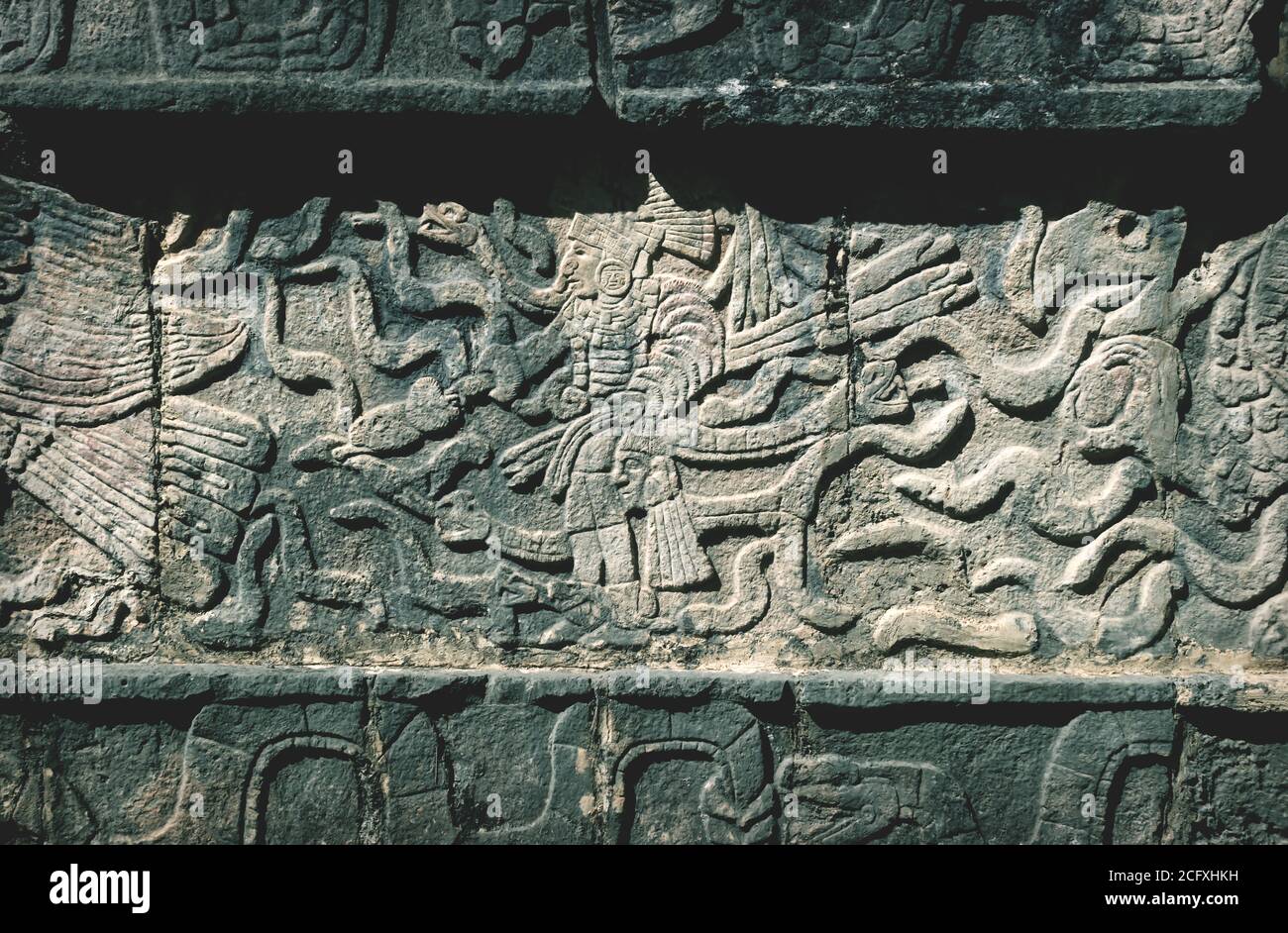 Closeup of carved Maya figures in a stone Mayan temple in Chichen Itza