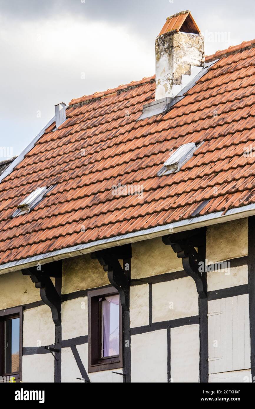 Vertical closeup shot of a vintage house with a red roof Stock Photo