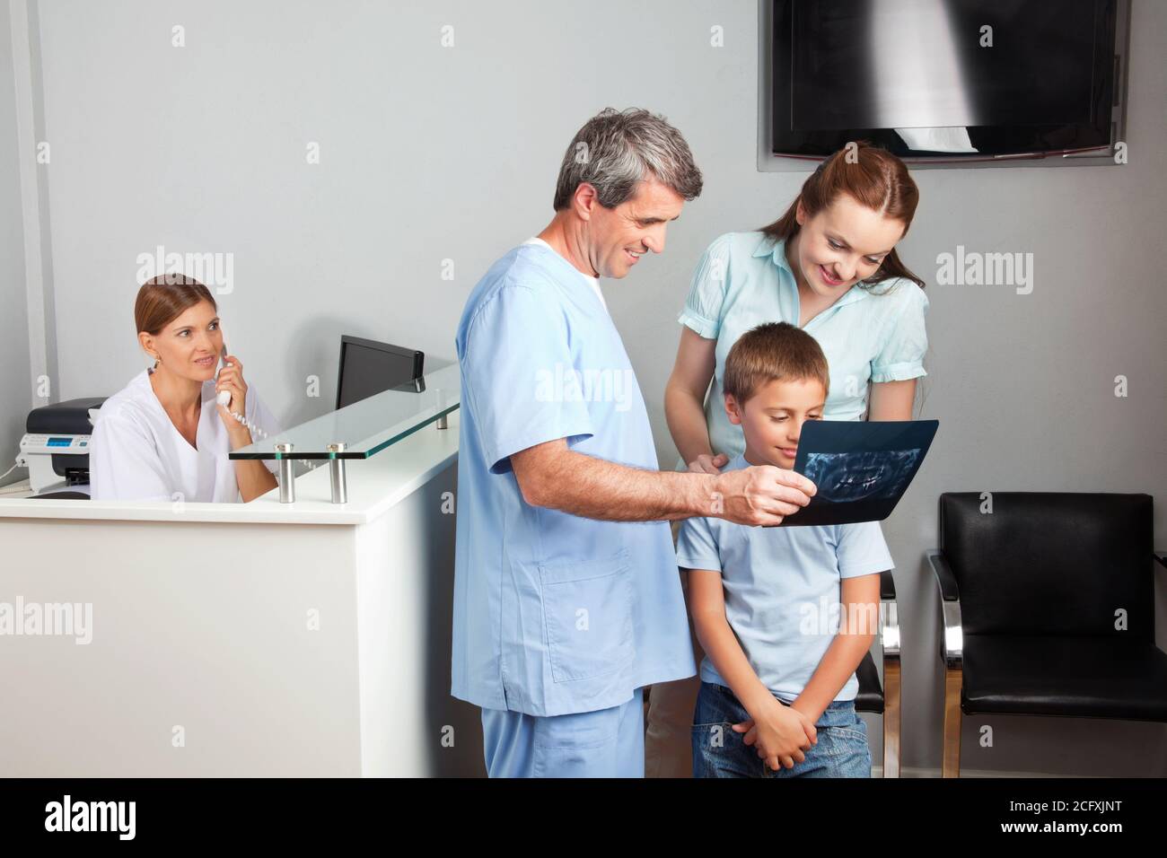 Mother and son look at an x-ray with a doctor Stock Photo - Alamy