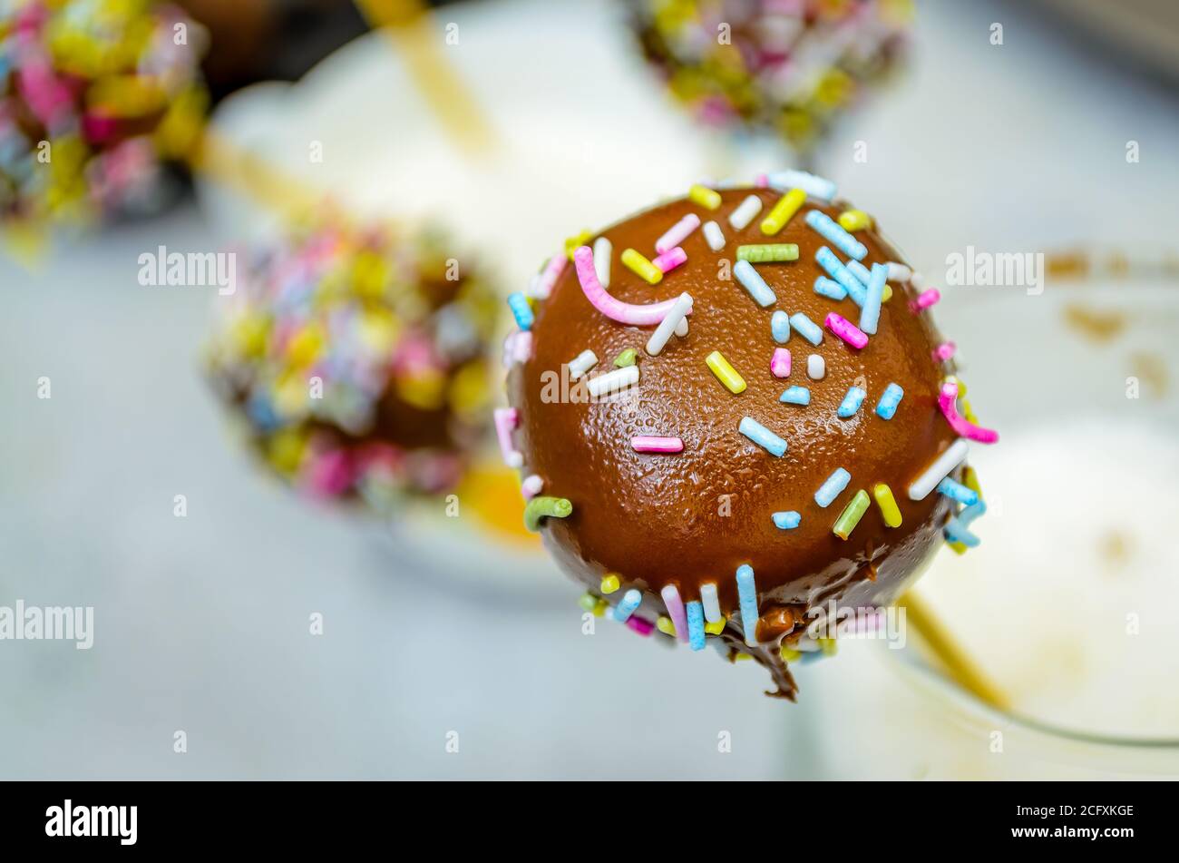 Chocolate Cake Pops with colorful Sugar Strand sprinklers. Macro Shot. Stock Photo