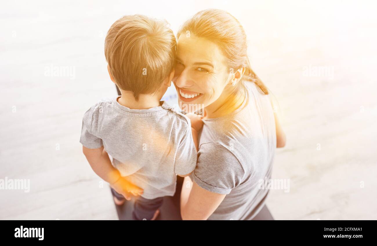 Happy mother with child smiling with laptop computer in hand Stock Photo