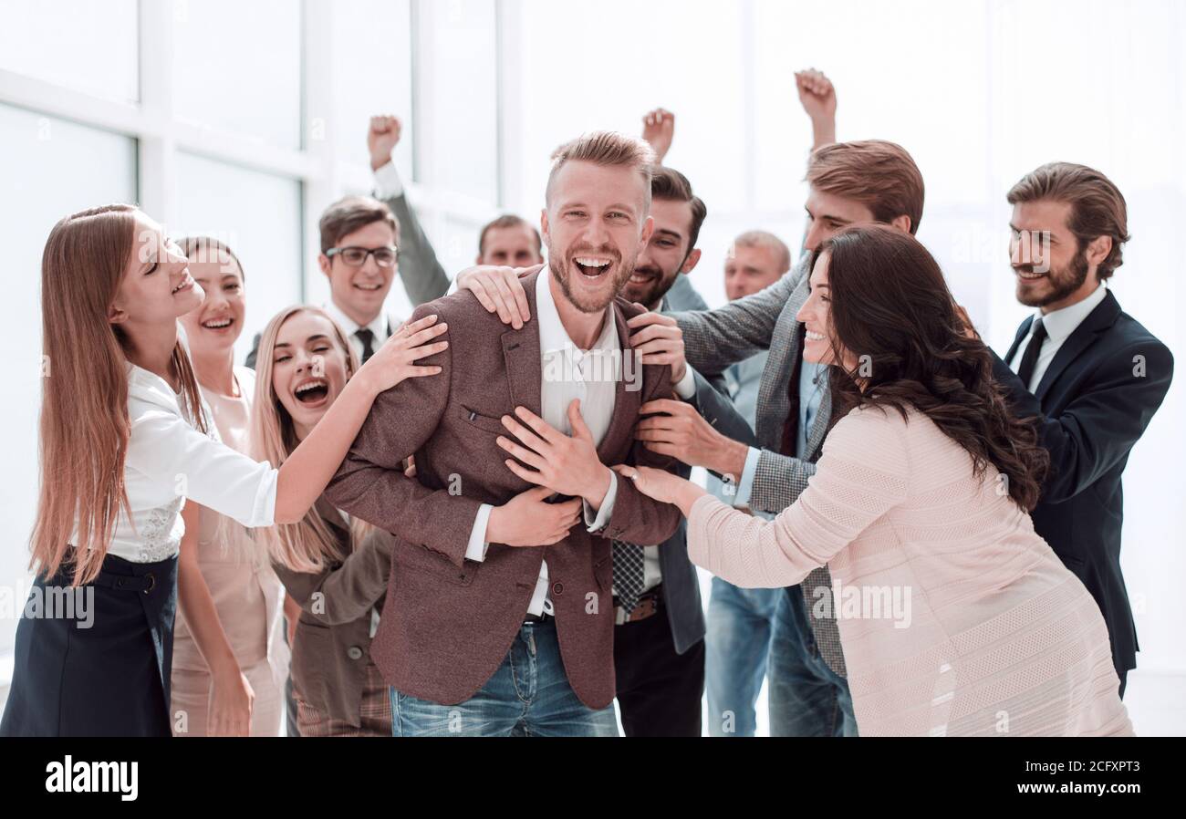 happy team of employees congratulating their colleague. Stock Photo