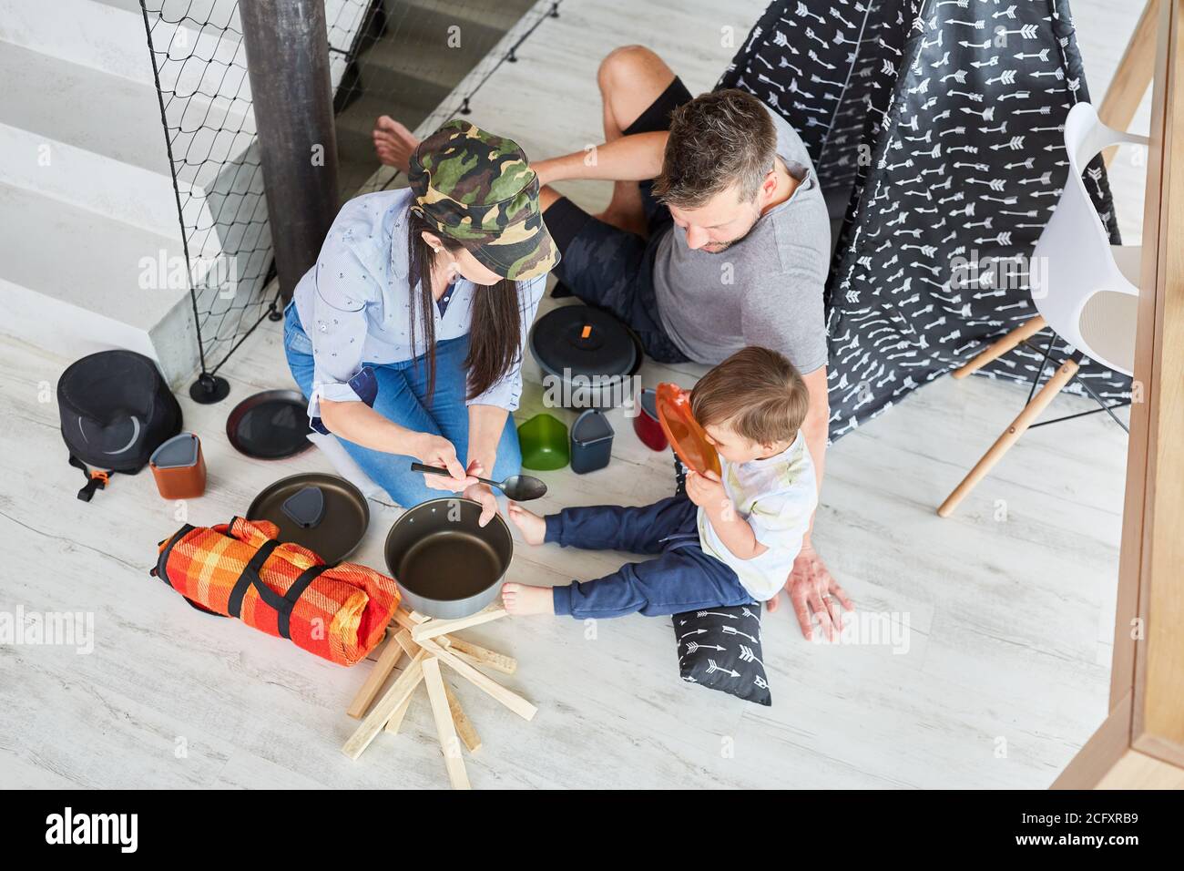 Family and child playing camping and camping at home in the living room