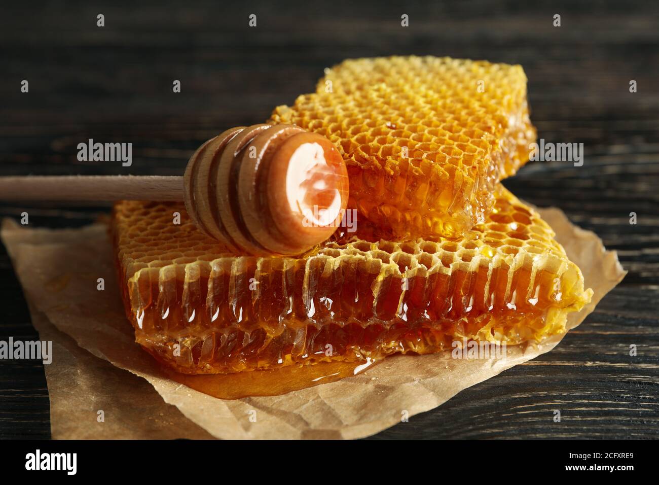 Baking paper with pieces and dipper on wooden background
