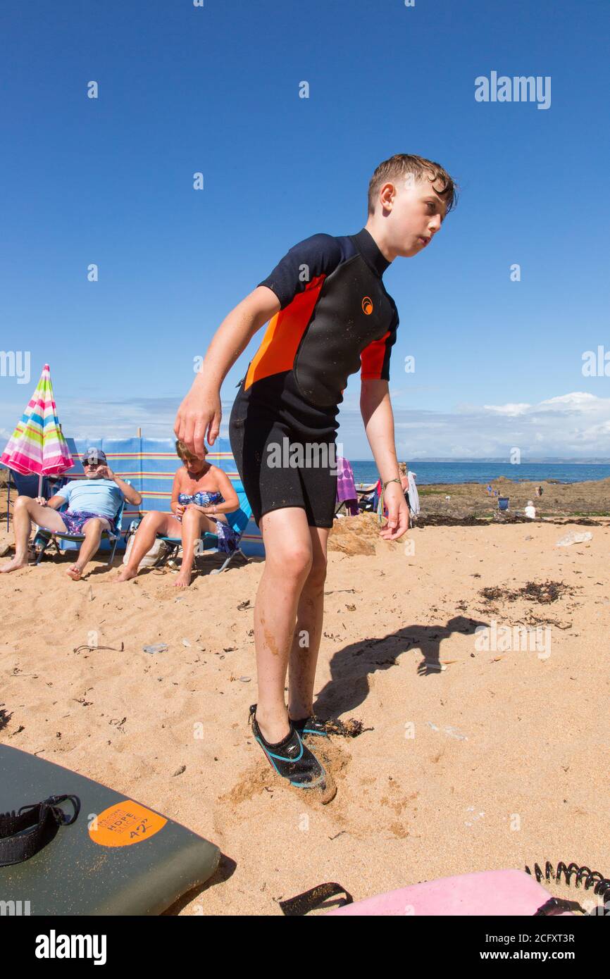 Eleven year old boy in a wetsuit at Hope Cove, Kingsbridge, Devon