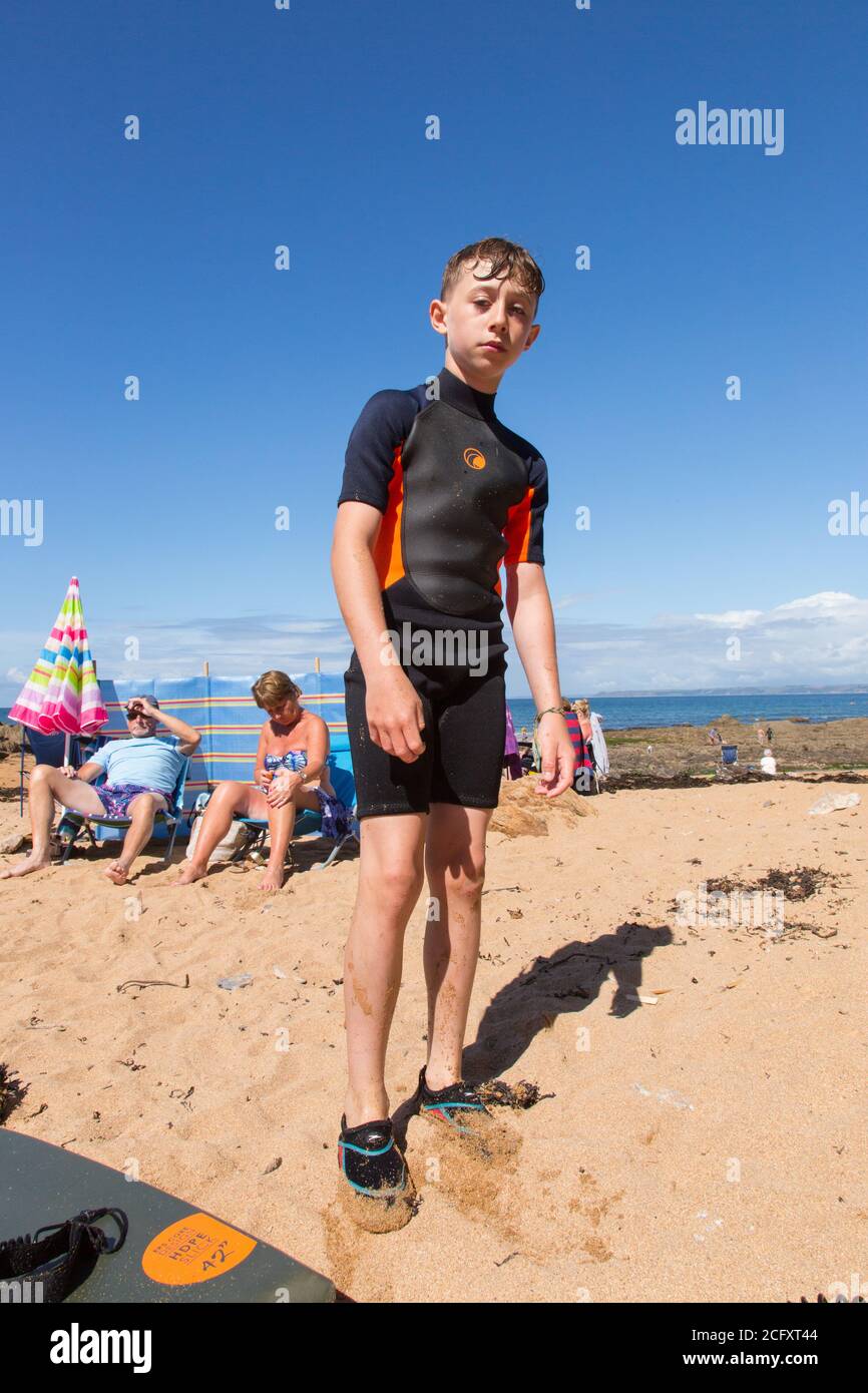 Eleven year old boy in a wetsuit at Hope Cove, Kingsbridge, Devon