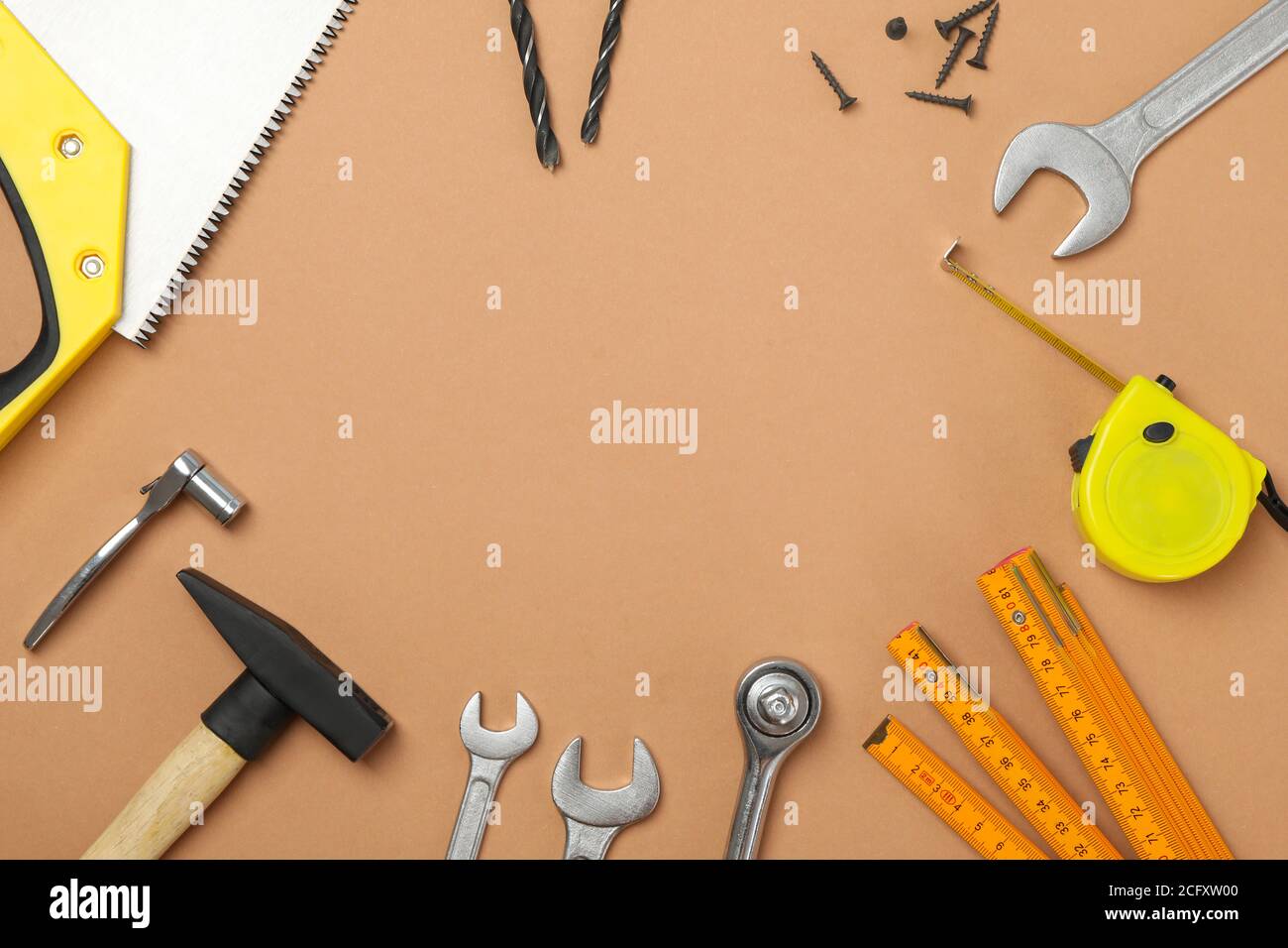 Construction tools on beige background, space for text Stock Photo