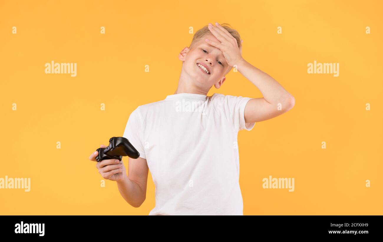 Sad boy playing video games at studio Stock Photo