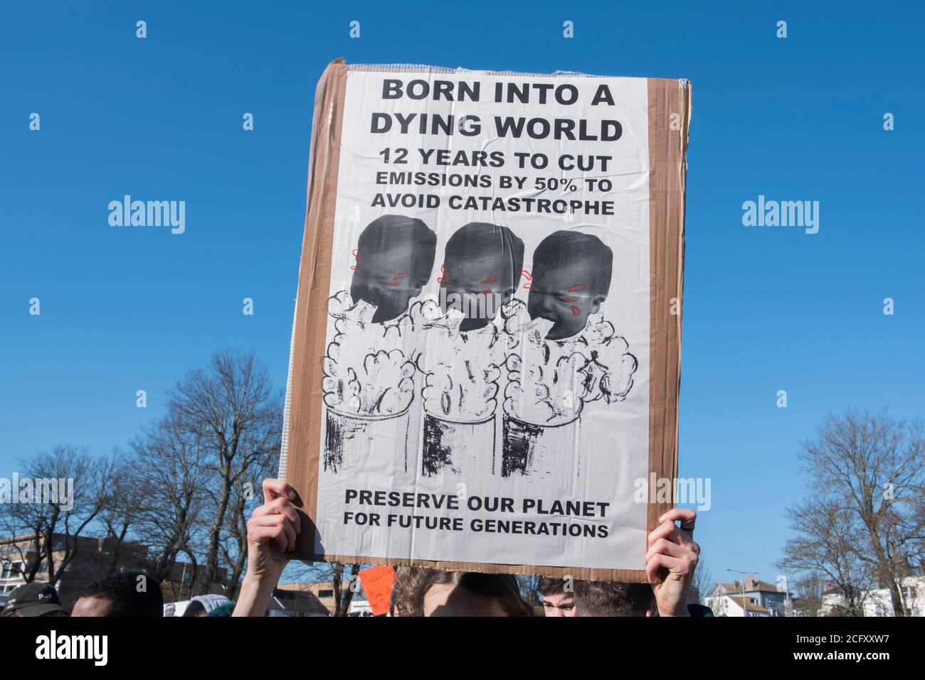 Signs at the school climate strike where youths protested about the growing Climate crisis that our planet is facing holding home made signs Stock Photo