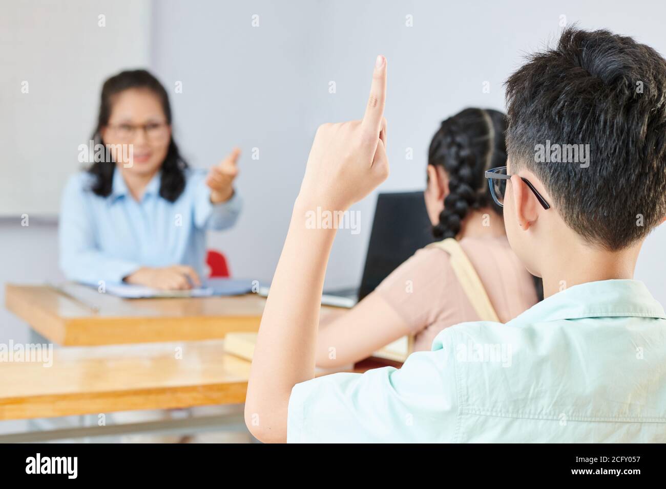 Schoolboy answering question Stock Photo