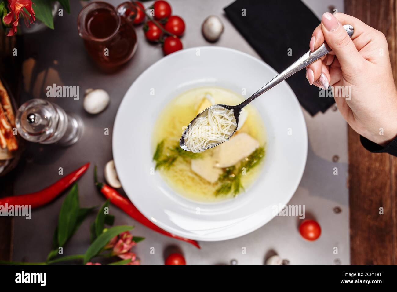 a white bowl filled with Delicious chicken noodle soup Stock Photo