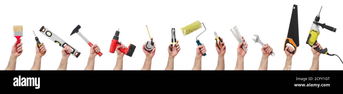 Hands raised holding different tools Stock Photo