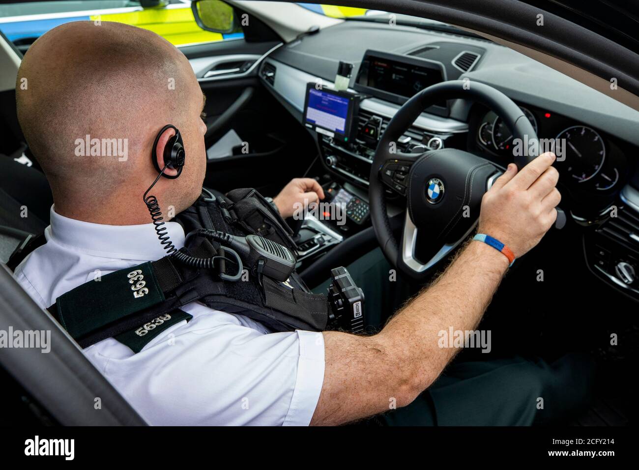 A PSNI Officer Sits In The Driving Seat Of A BMW Police Vehicle On Show