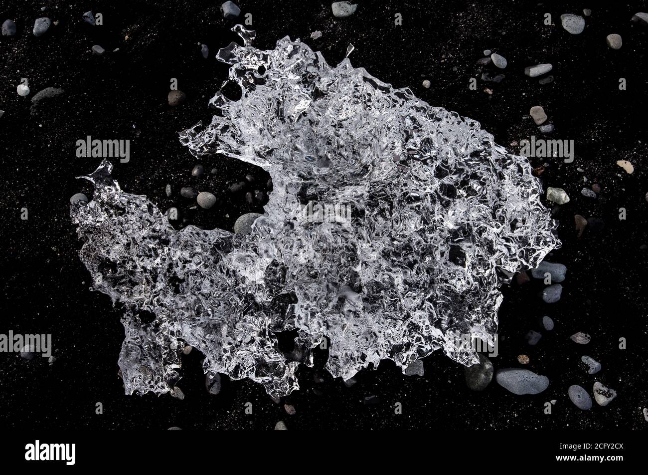Ice crystal on a lava black beach Stock Photo