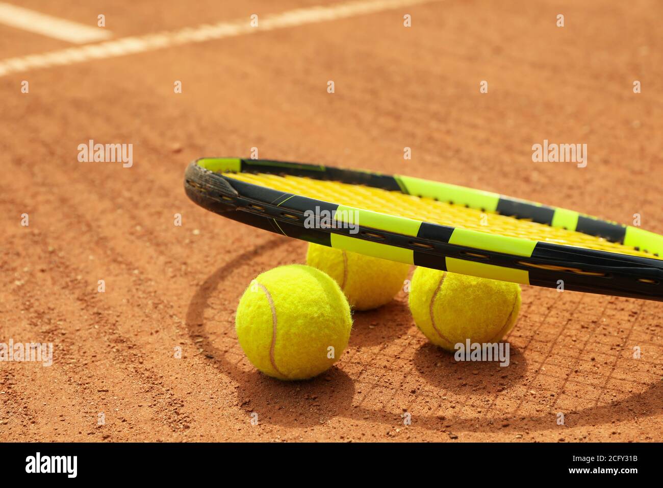 Racket and tennis balls on clay court Stock Photo Alamy