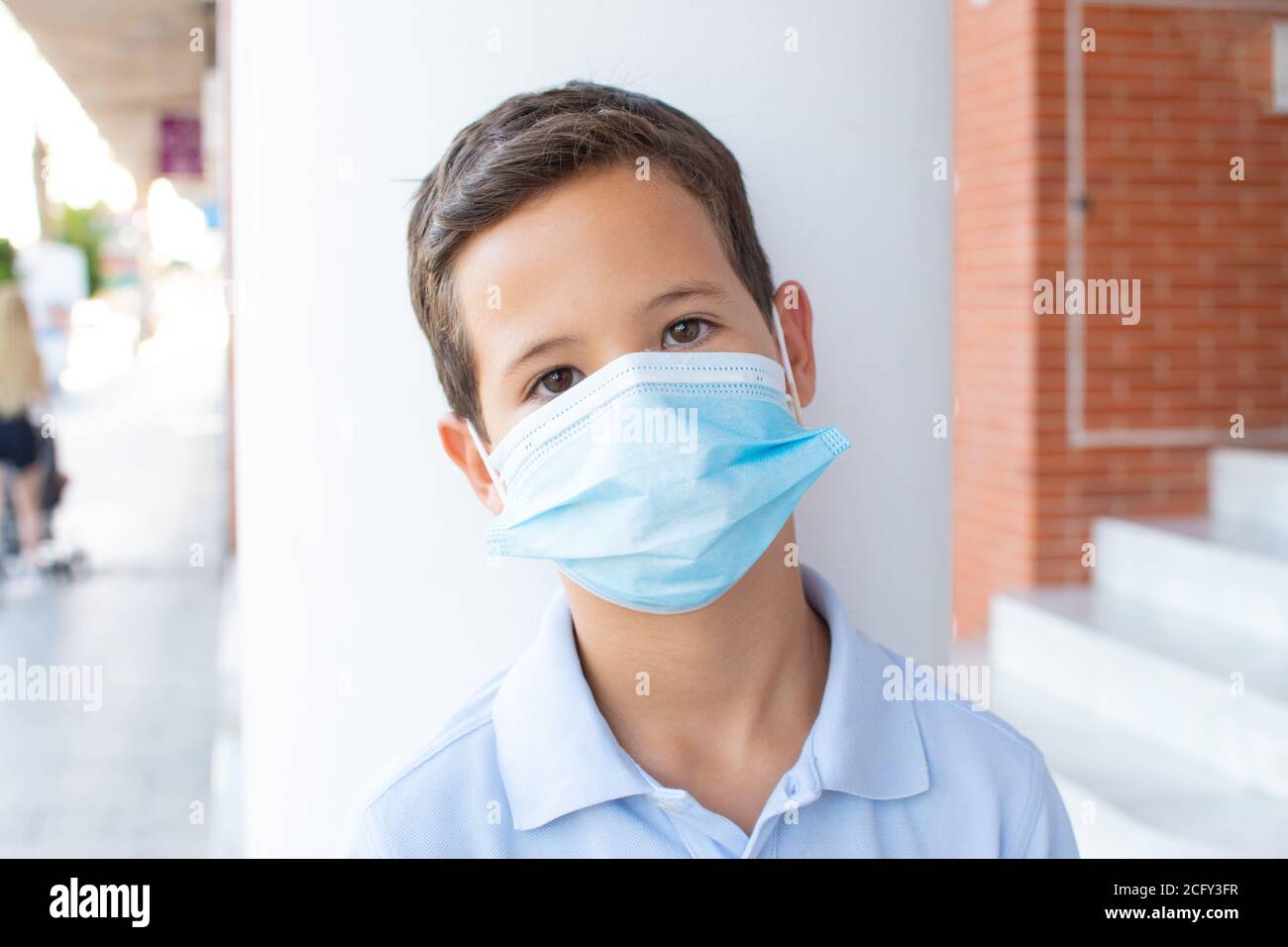 Boy wearing blue shirt with surgical mask Stock Photo - Alamy