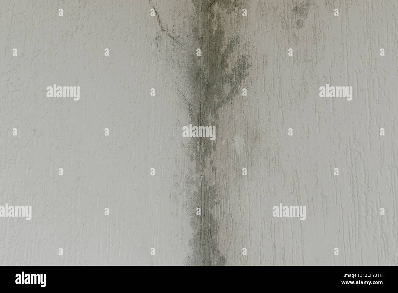 infiltration of water, mold and cracks in the wall and white roof of the house Stock Photo