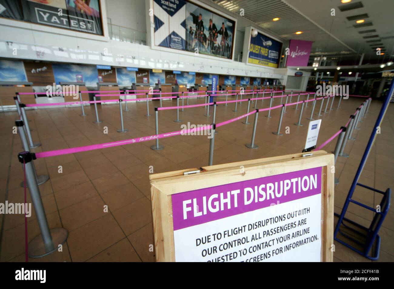 Glasgow Prestwick Airport, Ayrshire, Scotland. 16 April 2010, Terminal Building empty as a result of Icelandic Volcanic Ash closing UK airspace. Concorse empty with solitary figure on phone Stock Photo