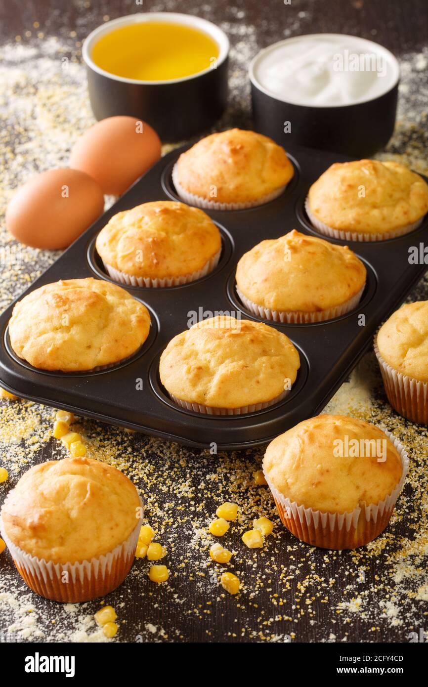 https://c8.alamy.com/comp/2CFY4CD/delicious-snack-corn-muffins-in-a-baking-dish-and-ingredients-close-up-on-the-table-vertical-2CFY4CD.jpg