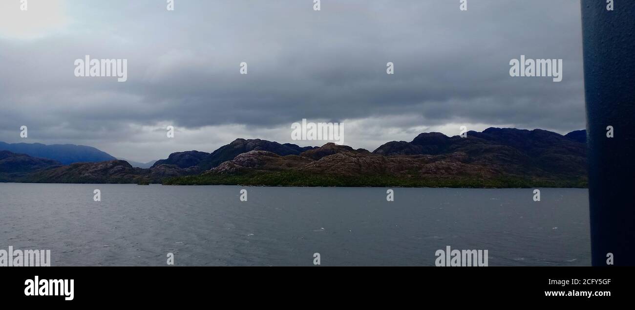mountain cloudy sky and clam ocean Stock Photo