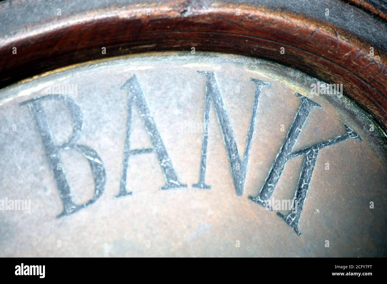 Old fashioned vintage bank sign above its financial business building