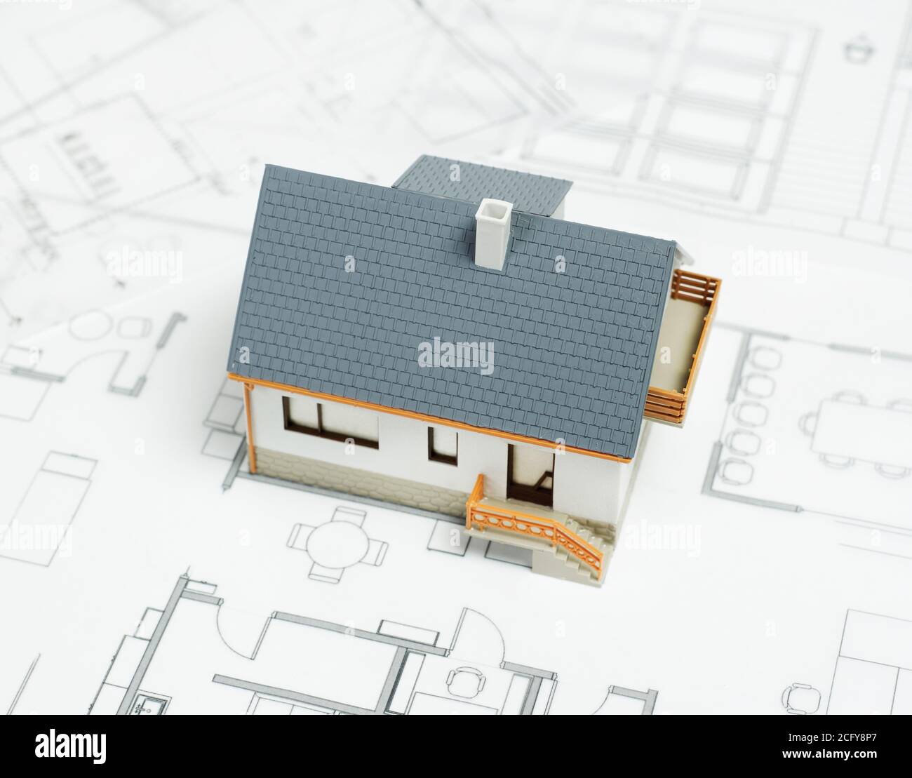 Model house on top of blueprints Stock Photo