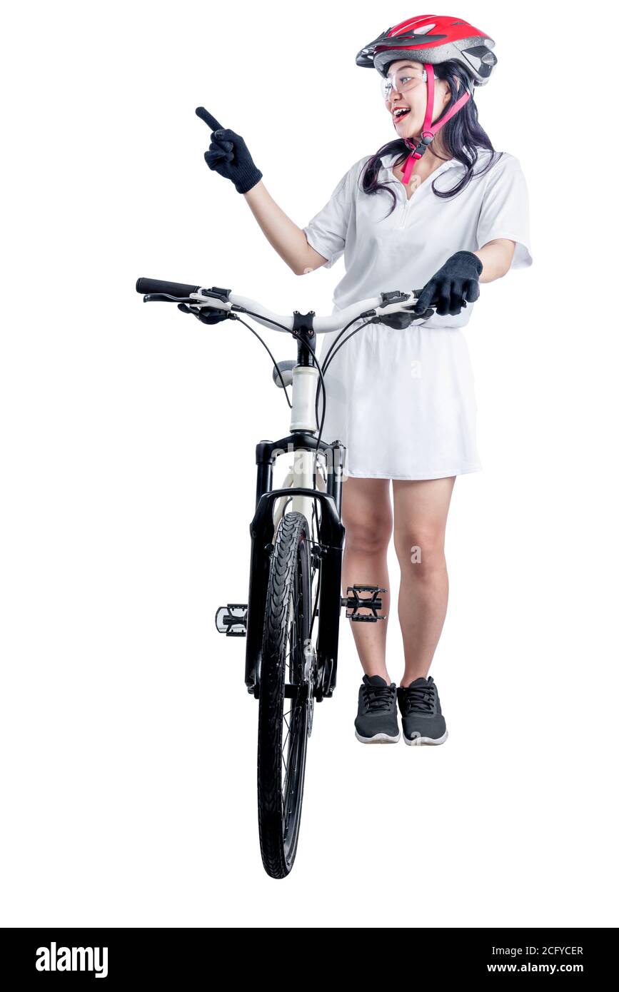 Asian woman with a bicycle helmet standing beside her bicycle isolated over white background Stock Photo