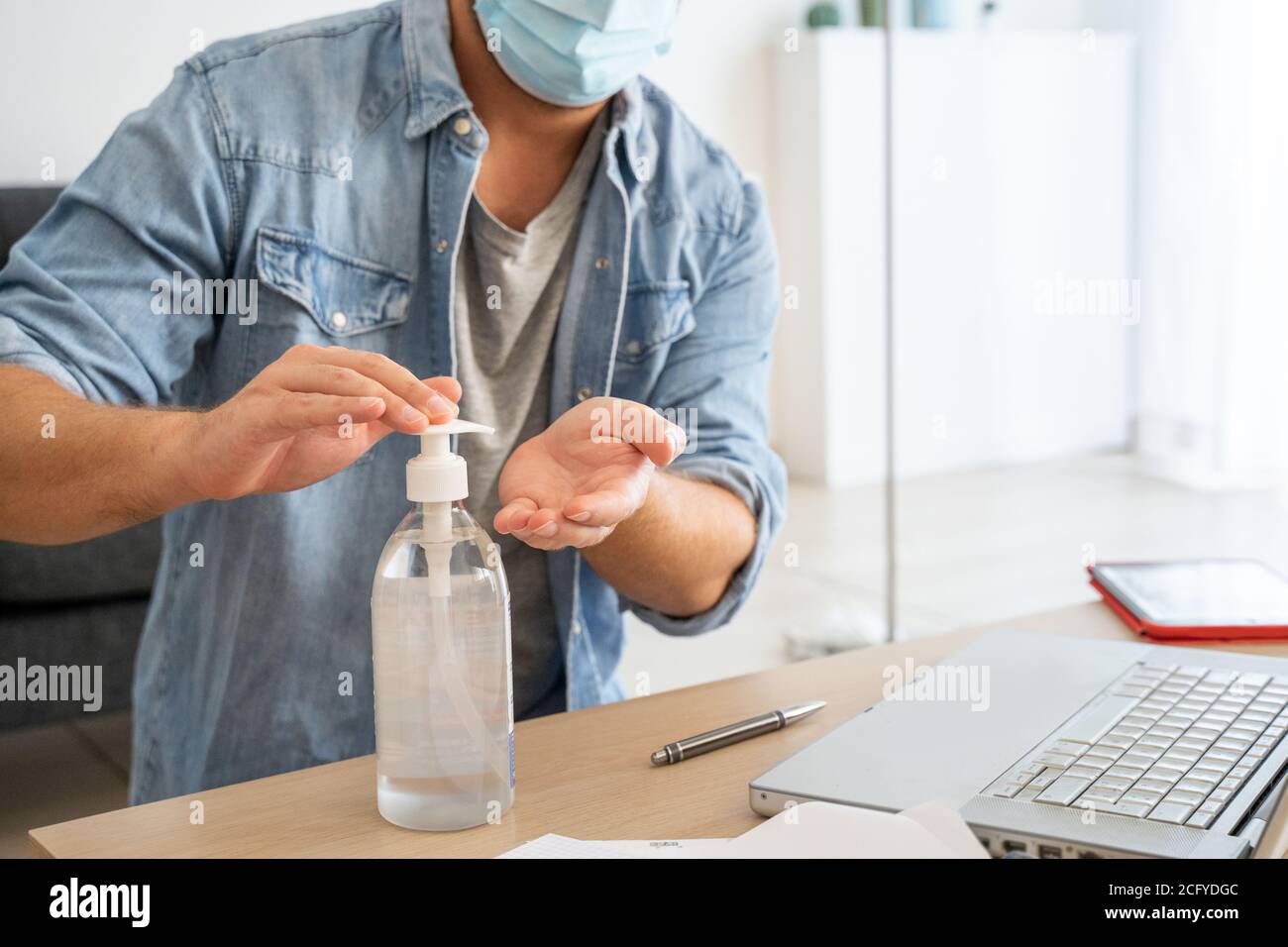 Man sanitizing tech stuff with hand sanitizer Stock Photo Alamy