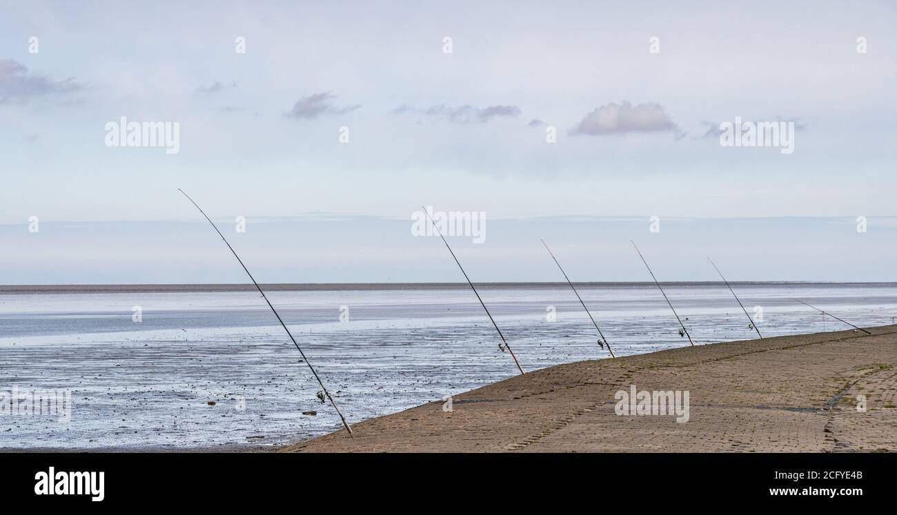 fishing rods placed at the wadden sea at north sea, germany Stock Photo