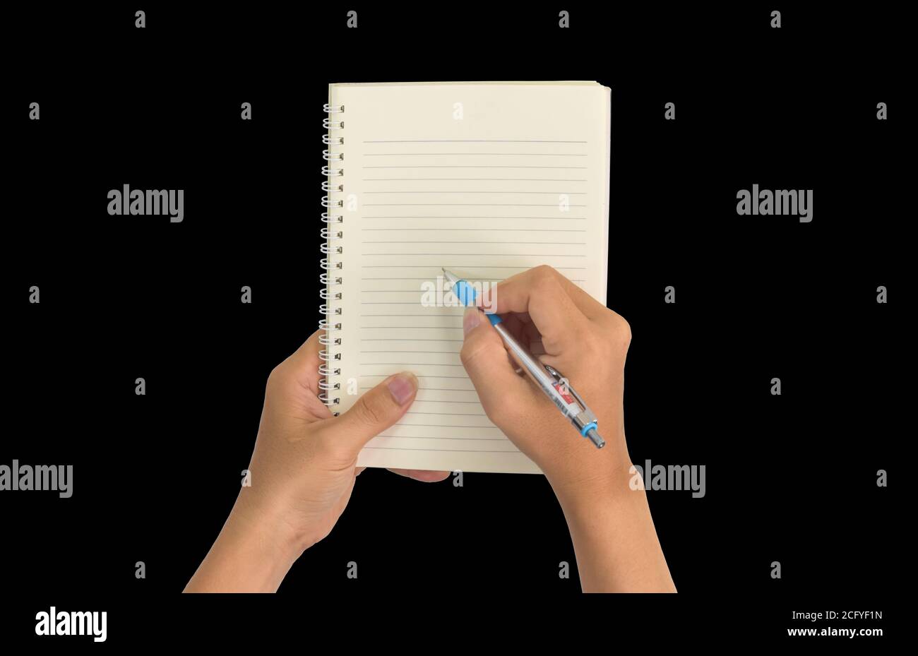 Hand holding pen, with a blank notes over blackboard background. Design concept Stock Photo