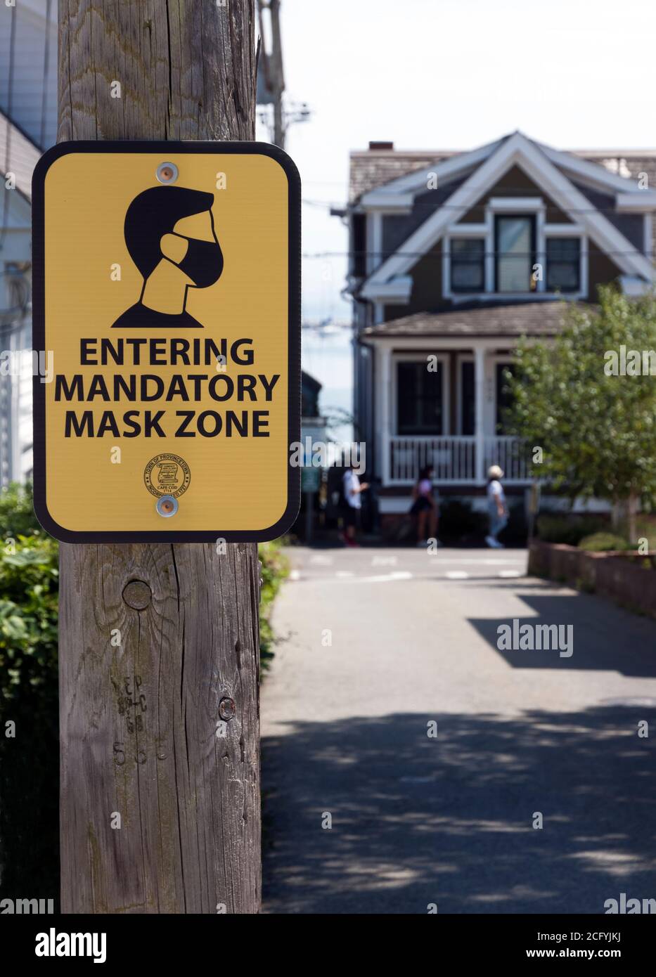 Sign for Mandatory Mask Zone in Provincetown, MA. To prevent spread of Covid-19, people must wear masks in the business district 24 hours a day. Stock Photo
