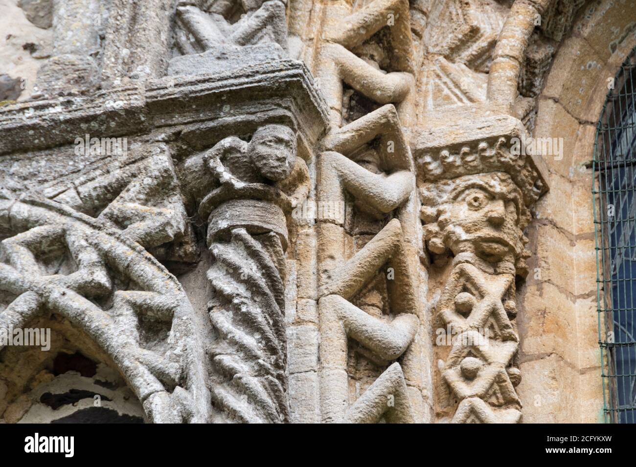 Norman carving on west front of St Lawrence church, Castle Rising in Norfolk. Stock Photo