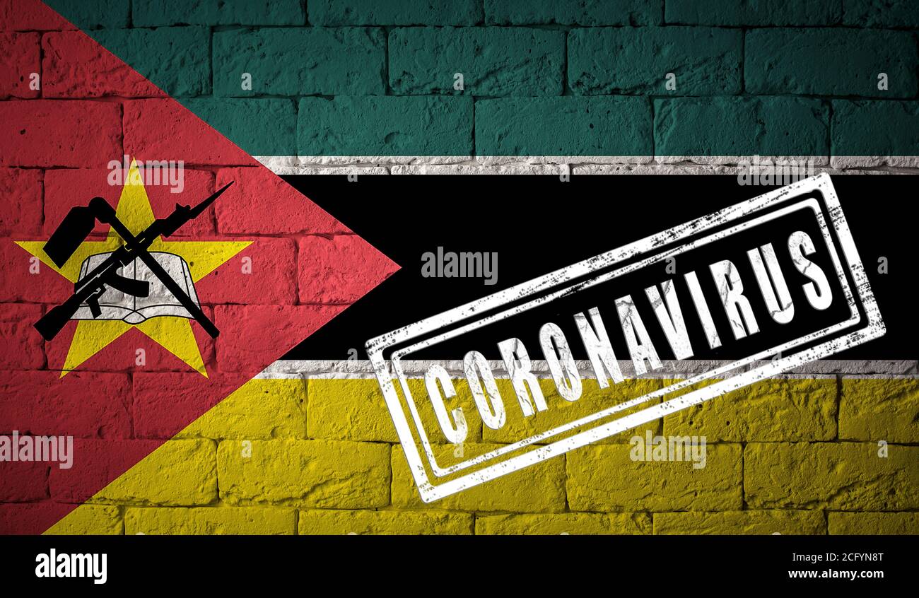 Flag of the Mozambique on brick wall texture. stamped of Coronavirus. Corona virus concept. On the verge of a COVID-19 or 2019-nCoV Pandemic. Novel Ch Stock Photo