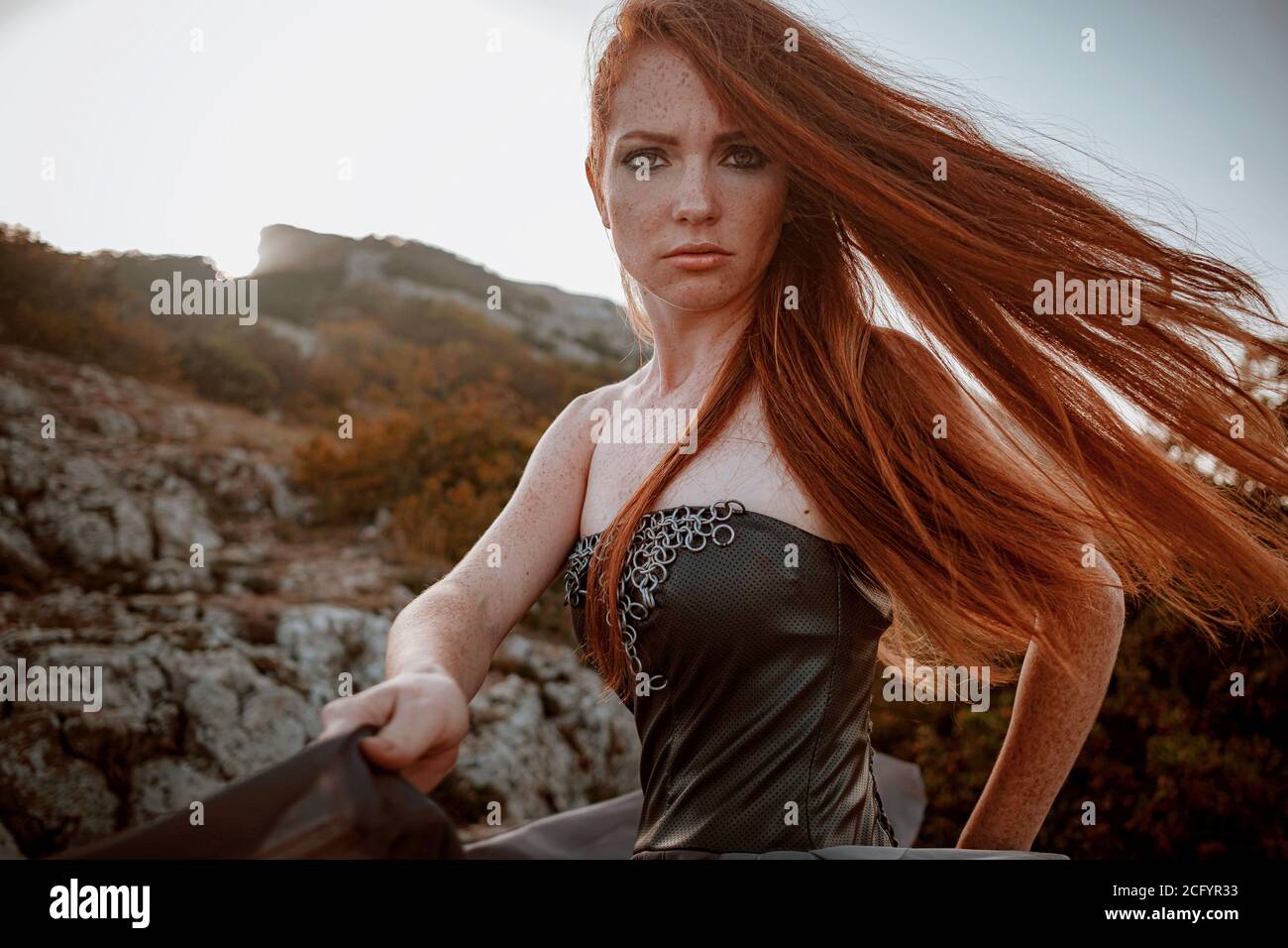 beautiful furious scandinavian warrior ginger woman in grey dress with  metal chain mail. Woman is a Viking. Fantasy. Book Cover. beautifully  flying dr Stock Photo - Alamy