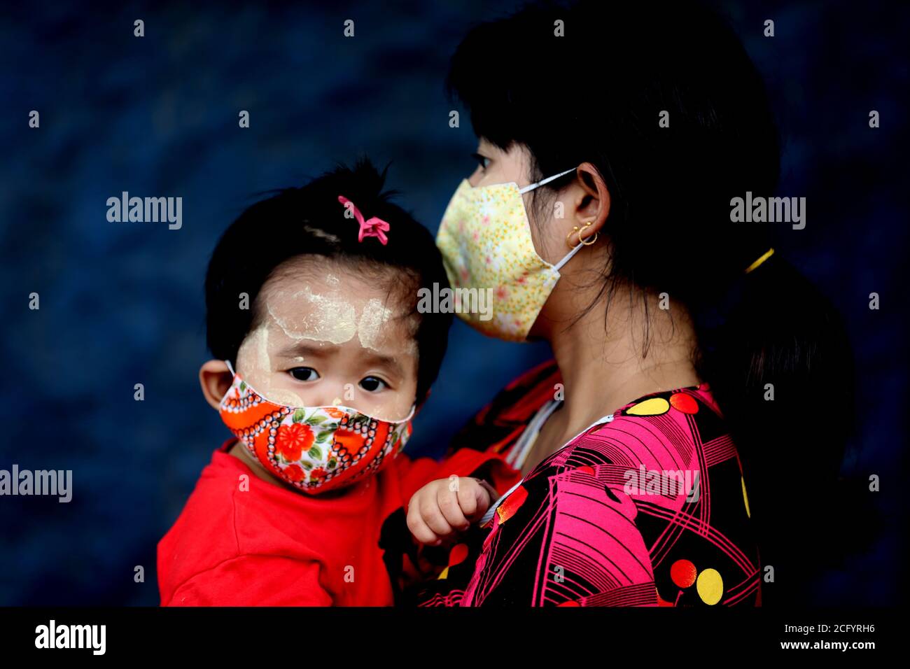 Yangon, Myanmar. 8th Sep, 2020. A mother and her child wearing face masks stand in line while waiting to get their health checked during a medical checkup and contact tracing campaign in Yangon, Myanmar, Sept. 8, 2020. Myanmar reported 92 more new COVID-19 cases on Tuesday morning, according to a release from the Ministry of Health and Sports. Credit: U Aung/Xinhua/Alamy Live News Stock Photo