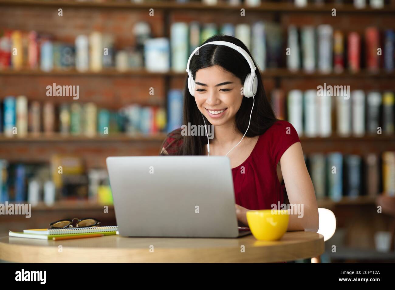 Freelancer Girl Working On Laptop And Listening Music In Headphones At ...